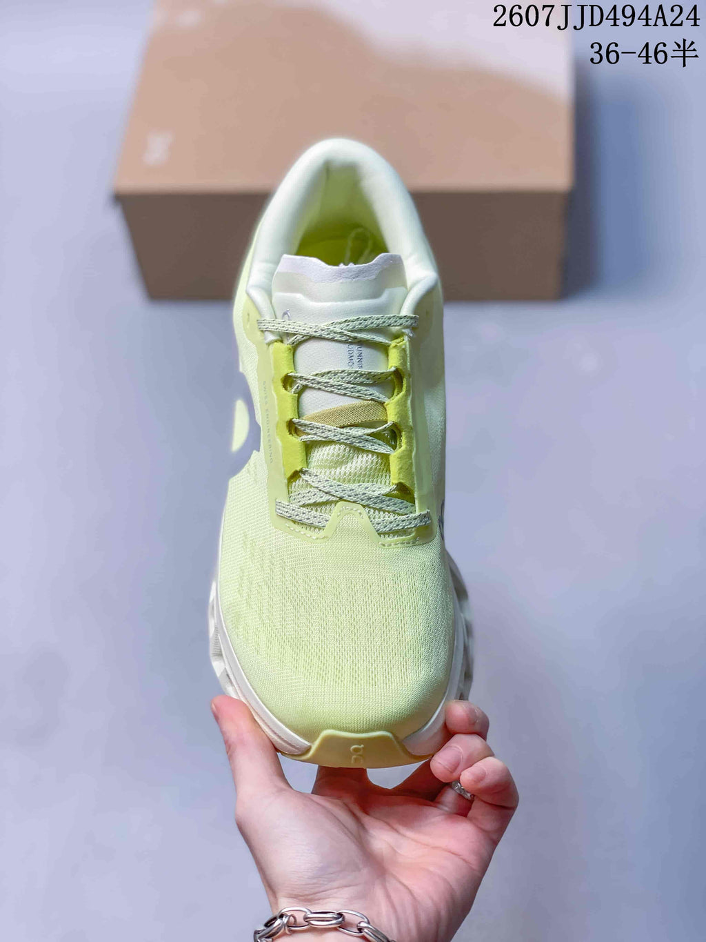 Top view of the sneaker showing the rounded toe, lace-up closure, and pale lime green upper.