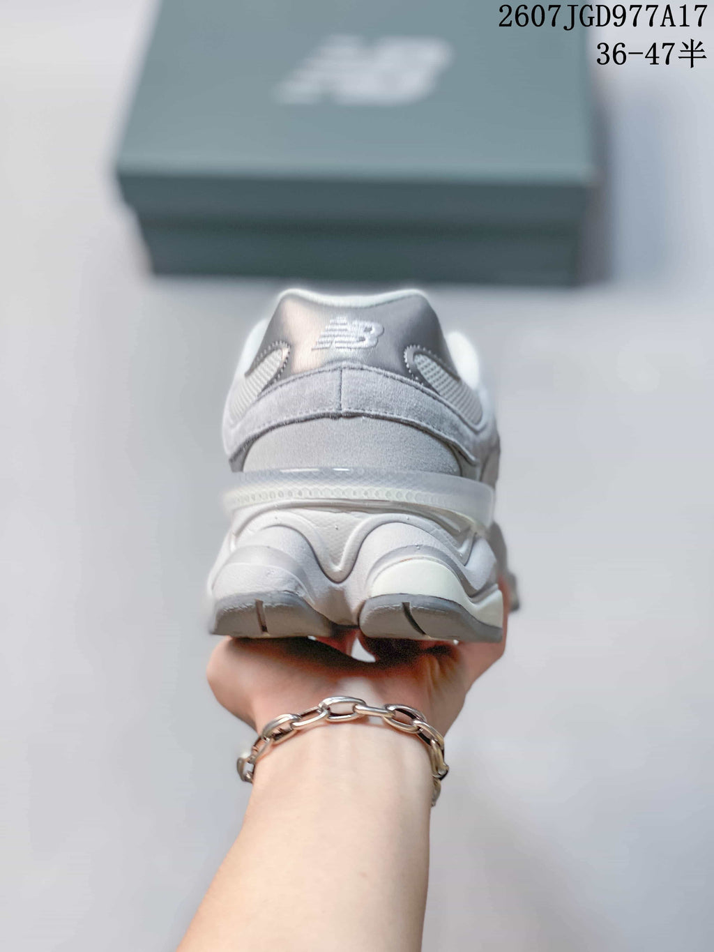 Rear view of the gray New Balance 9060 sneaker showing the padded heel collar and layered sculpted sole.