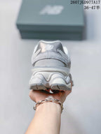 Rear view of the gray New Balance 9060 sneaker showing the padded heel collar and layered sculpted sole.