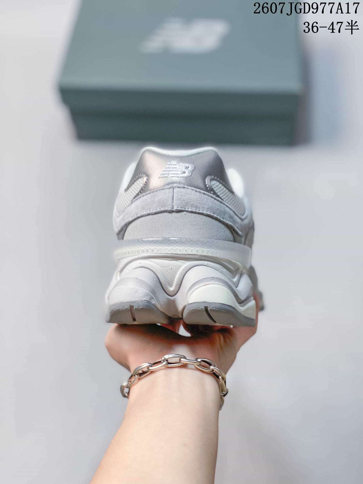 Rear view of the gray New Balance 9060 sneaker showing the padded heel collar and layered sculpted sole.