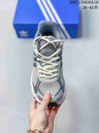 Top view of the sneaker showing the mesh toe box, cream laces, and gray tongue.