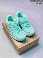 Pair of mint and teal ASICS Gel-Kayano 20 sneakers displayed on a shoe box.