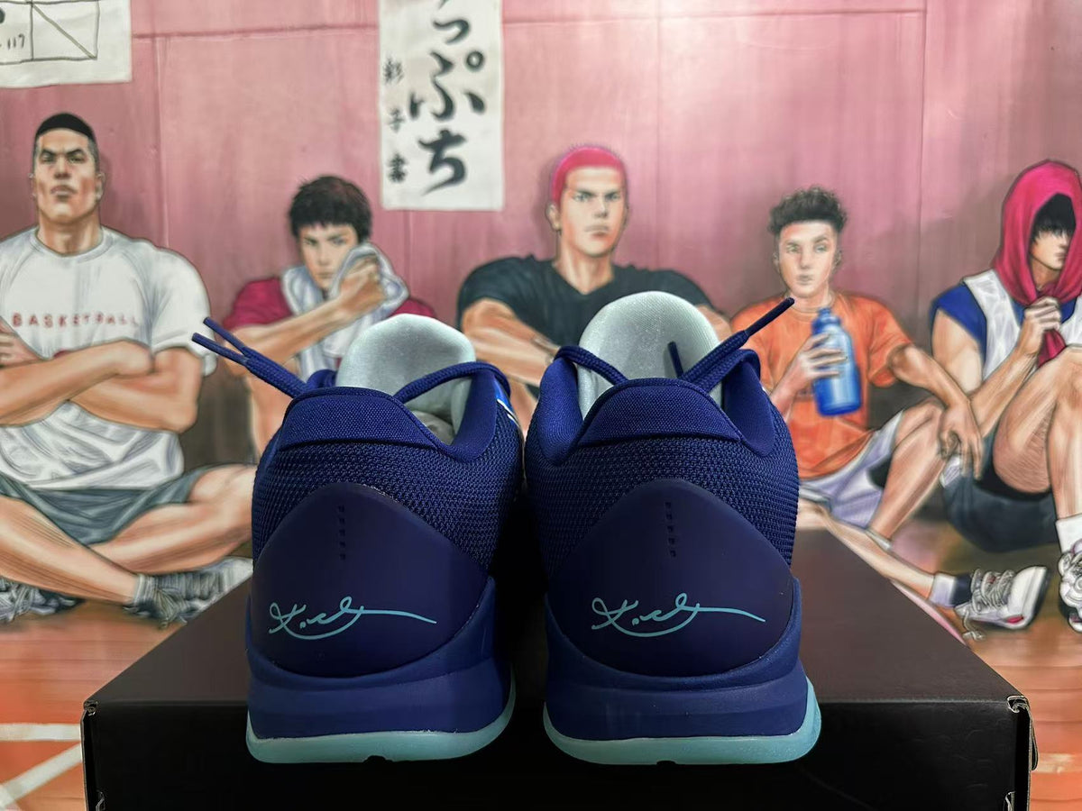 Rear view showing the padded heels and Kobe signature details on navy basketball shoes