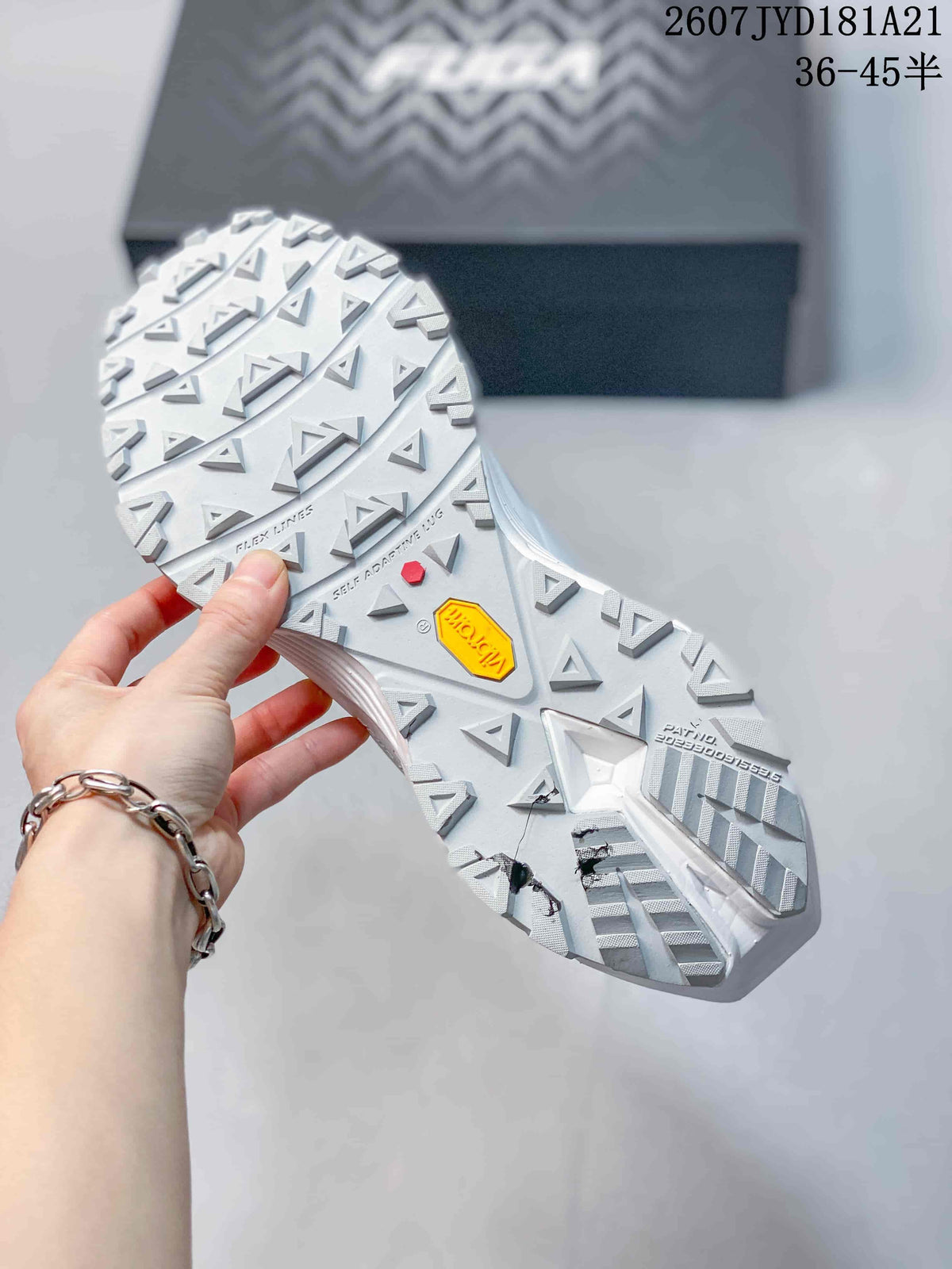 Close view of the white lugged outsole showing a Vibram mark and geometric traction pattern.