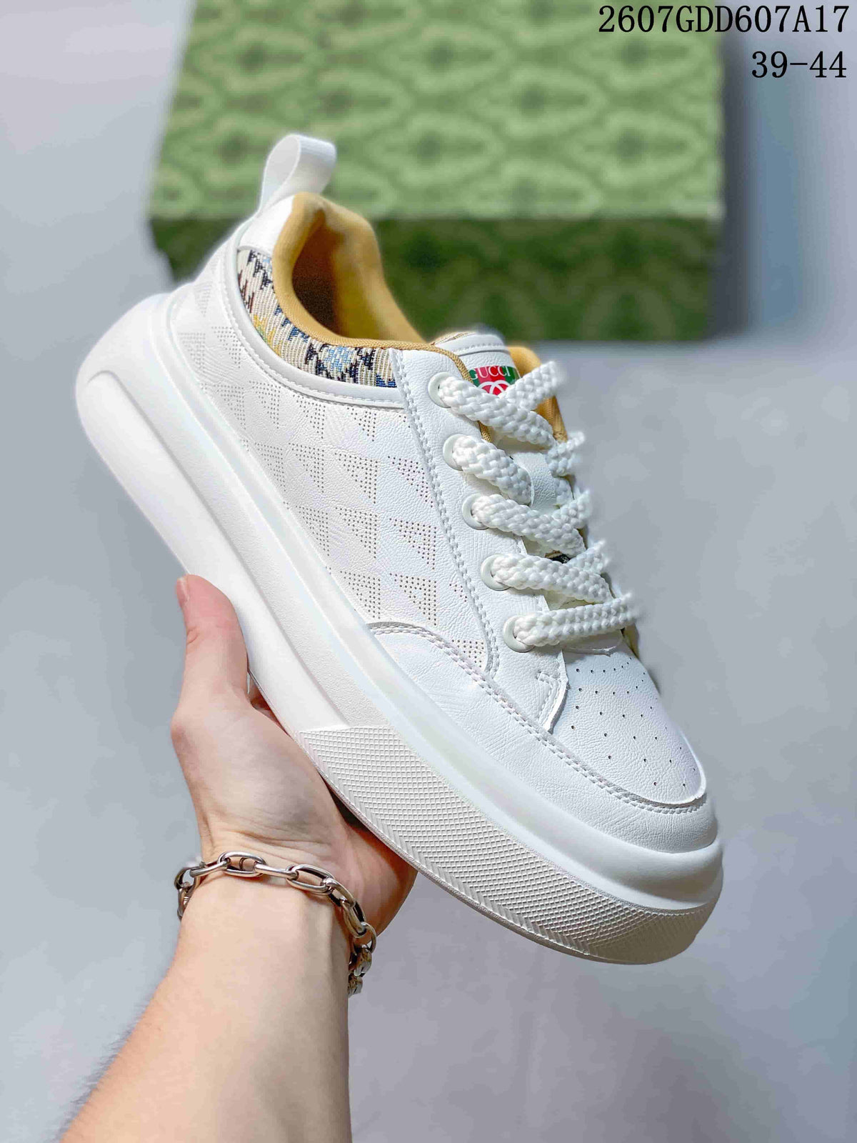 Angled side view showing the white sneaker upper, patterned collar trim and rubber outsole.