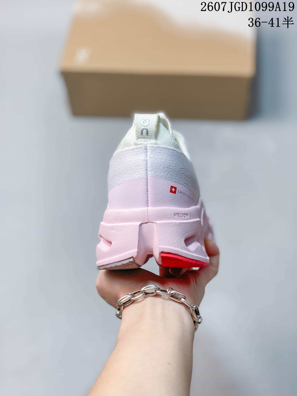 Rear view of the white and pink sneaker showing the heel construction, pull tab and visible On branding.