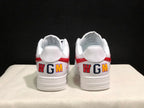 Rear view of the white sneakers showing red heel accents and multicolored WGM lettering.
