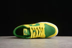 Top view showing the green perforated toe box, yellow laces, and padded collar.