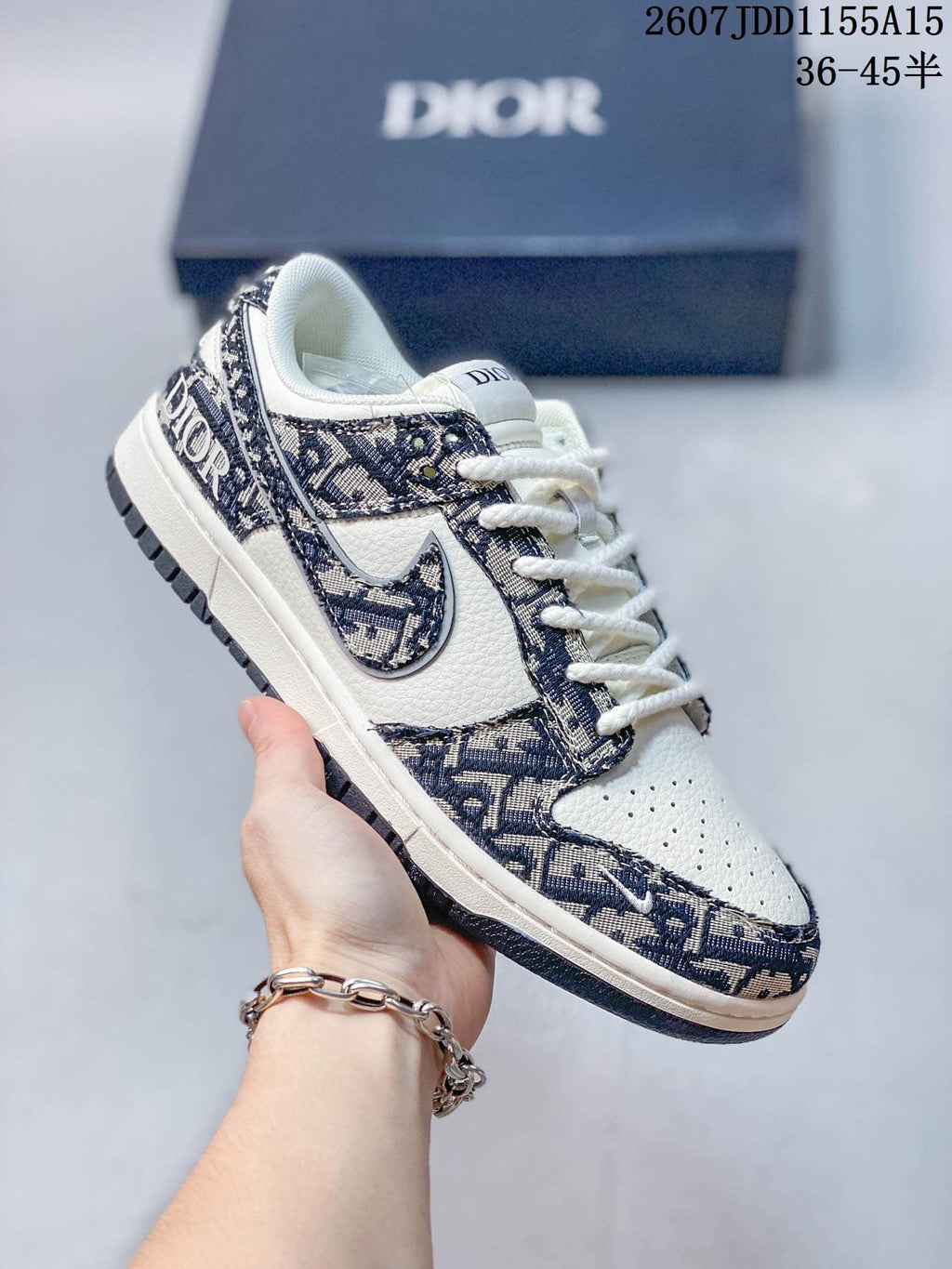 Close-up side view of a white and navy low-top sneaker with patterned panels, contrast Swoosh branding and a rubber outsole.