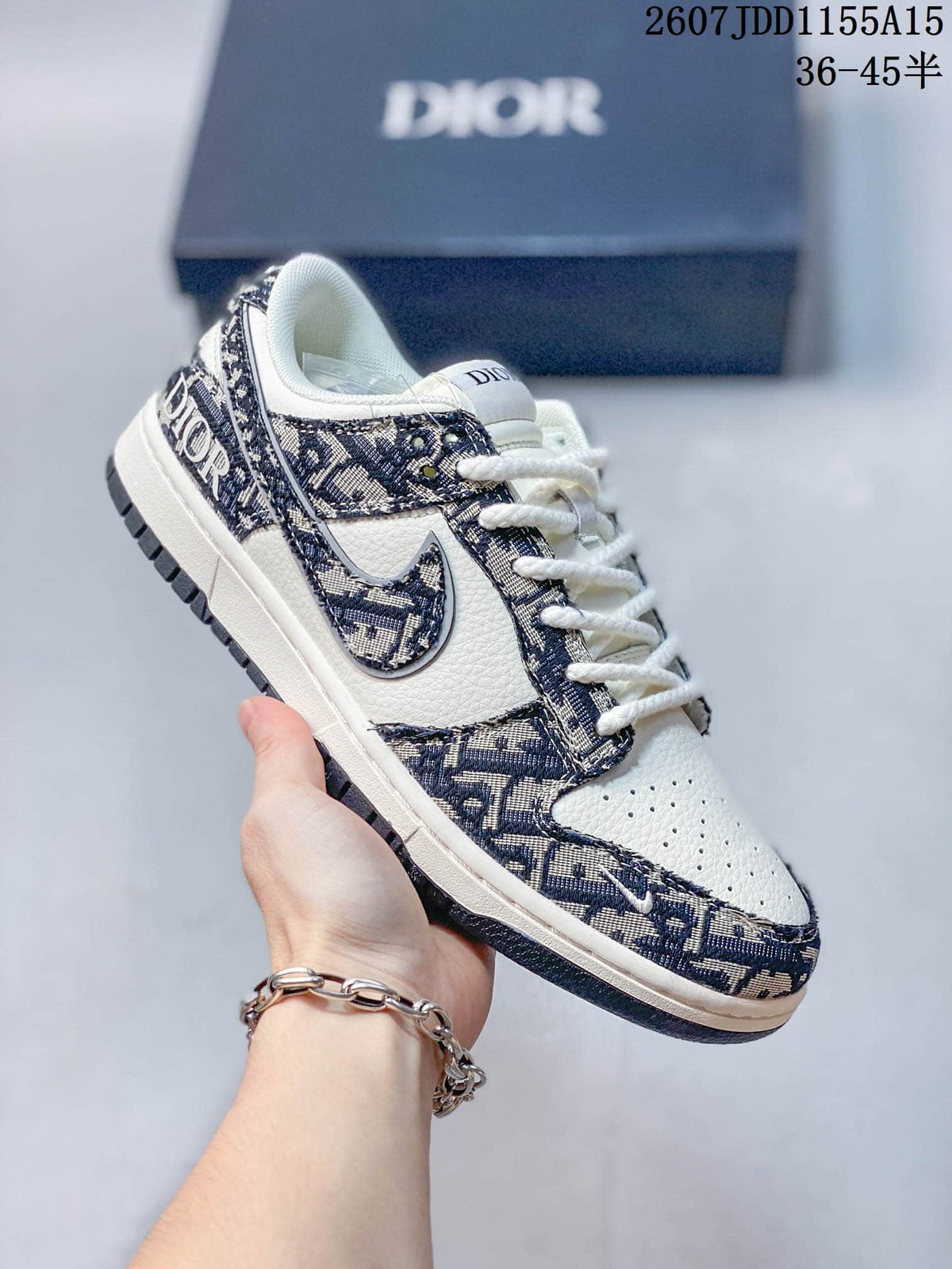 Close-up side view of a white and navy low-top sneaker with patterned panels, contrast Swoosh branding and a rubber outsole.