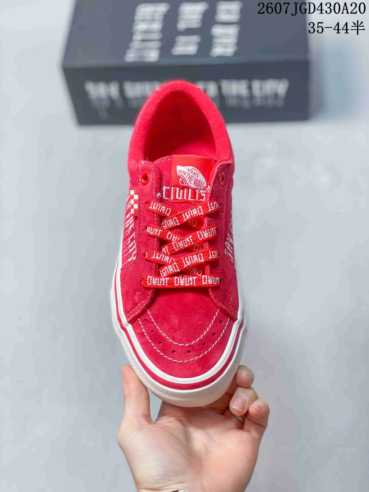 Top view of the red sneaker showing the toe stitching, patterned laces, eyelets, and tongue label.