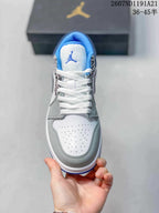Top view showing the white perforated toe box, grey overlays, white laces and blue-lined tongue.
