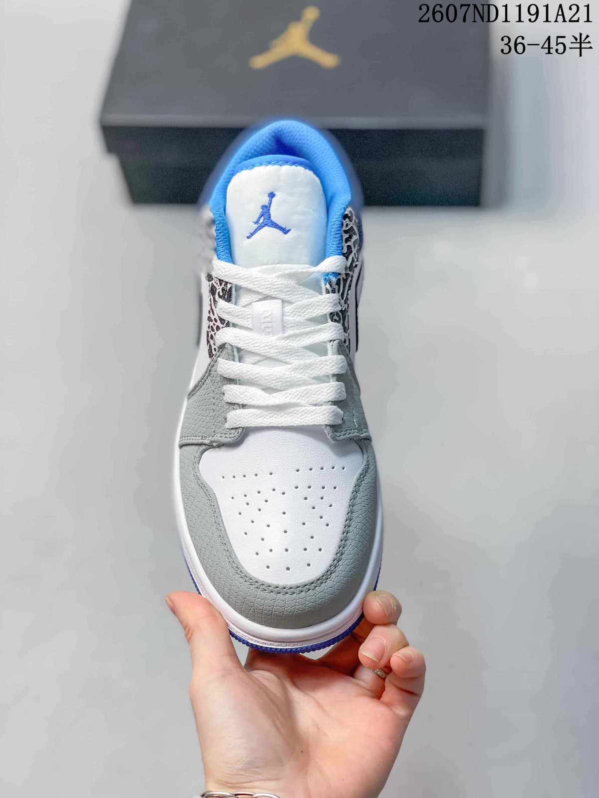 Top view showing the white perforated toe box, grey overlays, white laces and blue-lined tongue.