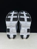 Bottom view showing white outsoles with black tread sections.