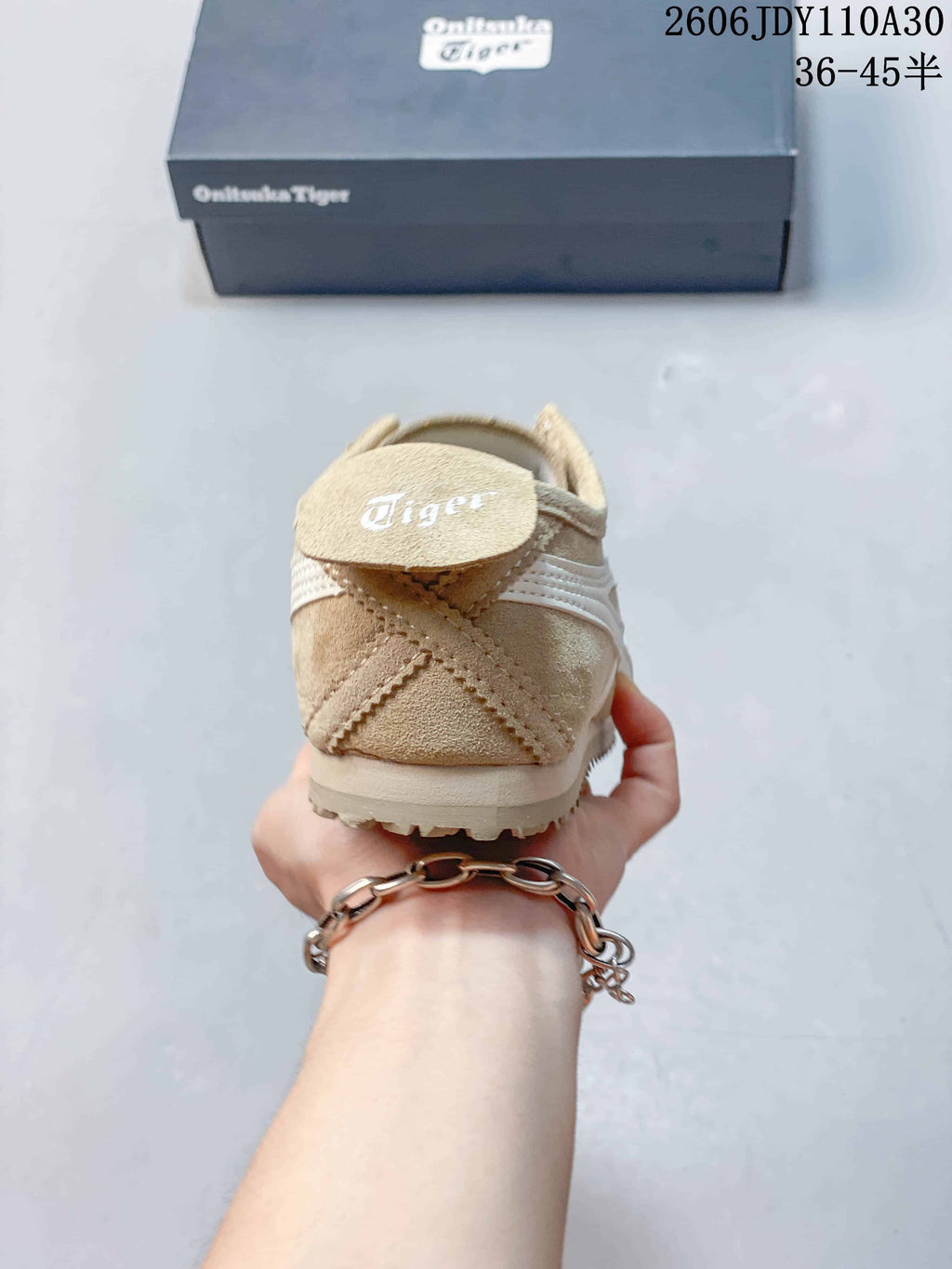 Rear view of a beige Onitsuka Tiger sneaker showing heel stitching and branding