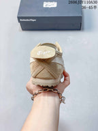 Rear view of a beige Onitsuka Tiger sneaker showing heel stitching and branding