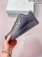 Side profile of a black Nike Air Force 1 '07 sneaker showing the tonal Swoosh, layered panels and low rubber sole.