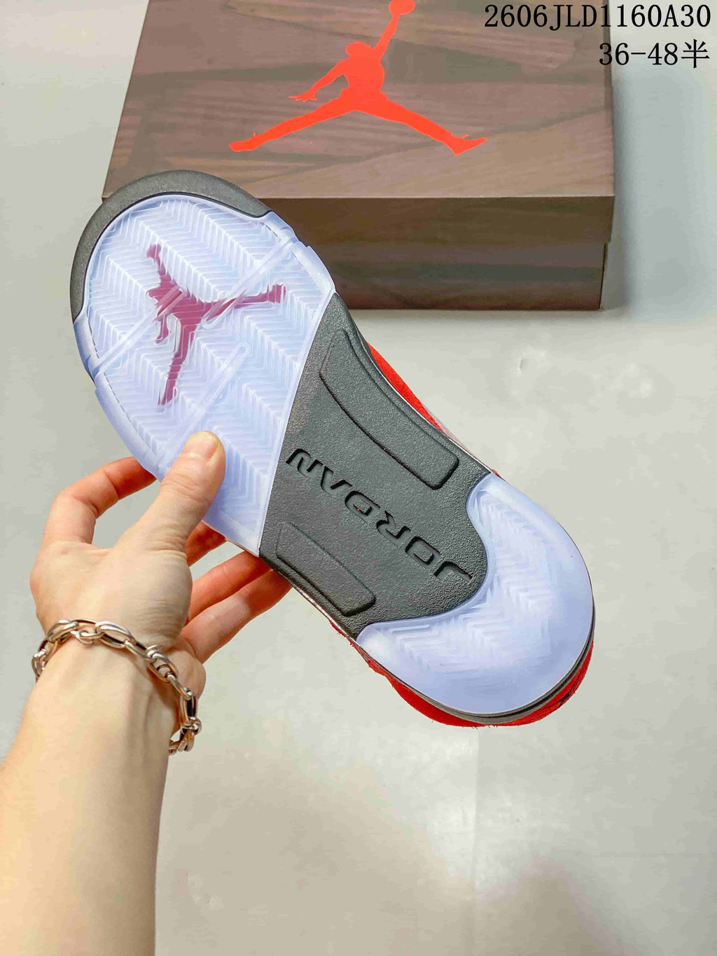 Underside of the sneaker showing a translucent outsole and dark midfoot section.
