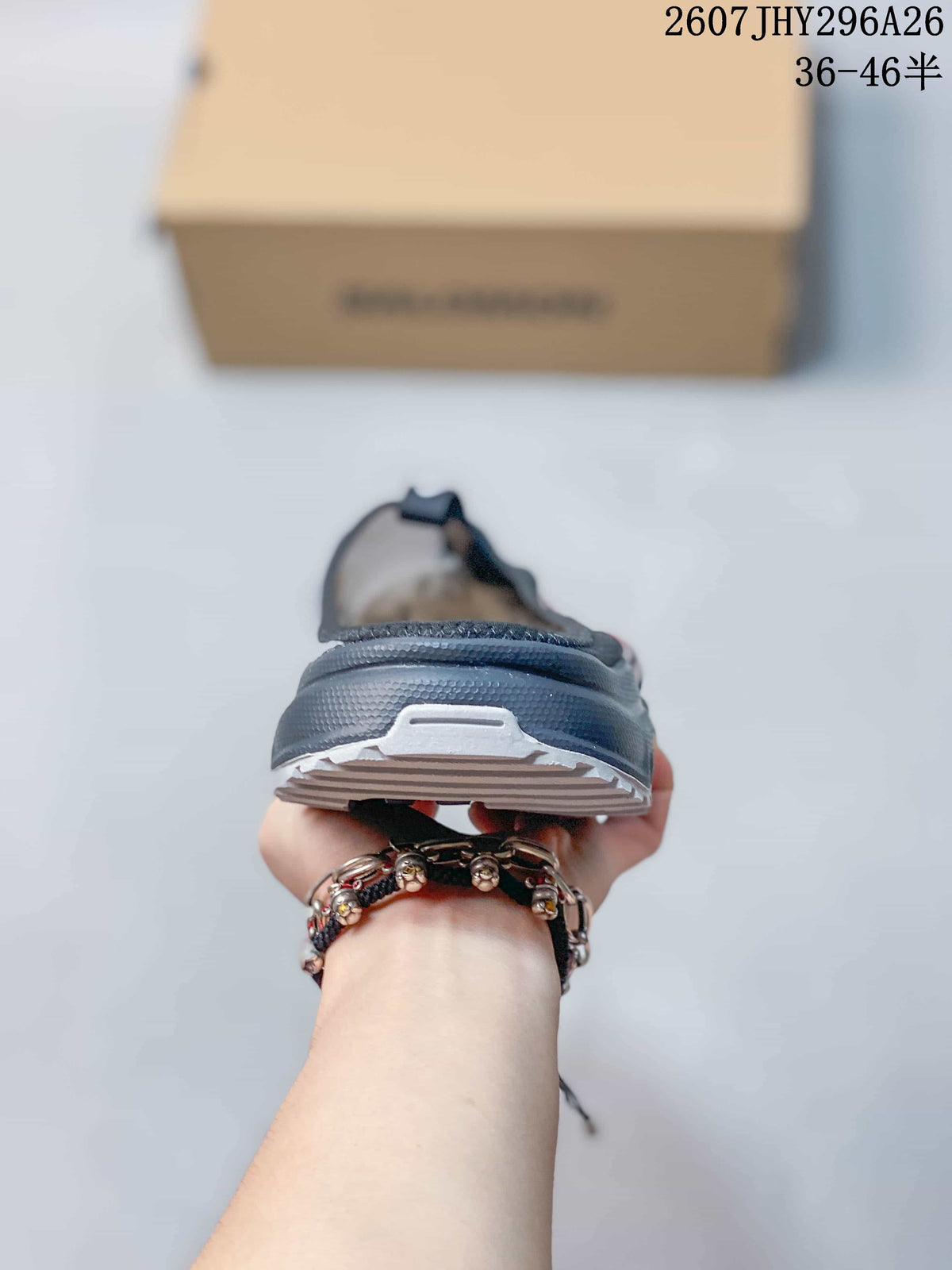 Rear view of the black mule showing the raised heel area and layered outsole construction.