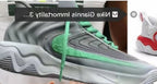 Grey and green basketball shoe shown in side view.