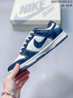 Side view highlighting the navy overlays, white panels with repeated OFF-WHITE text, contrast stitching, and Nike Swoosh.