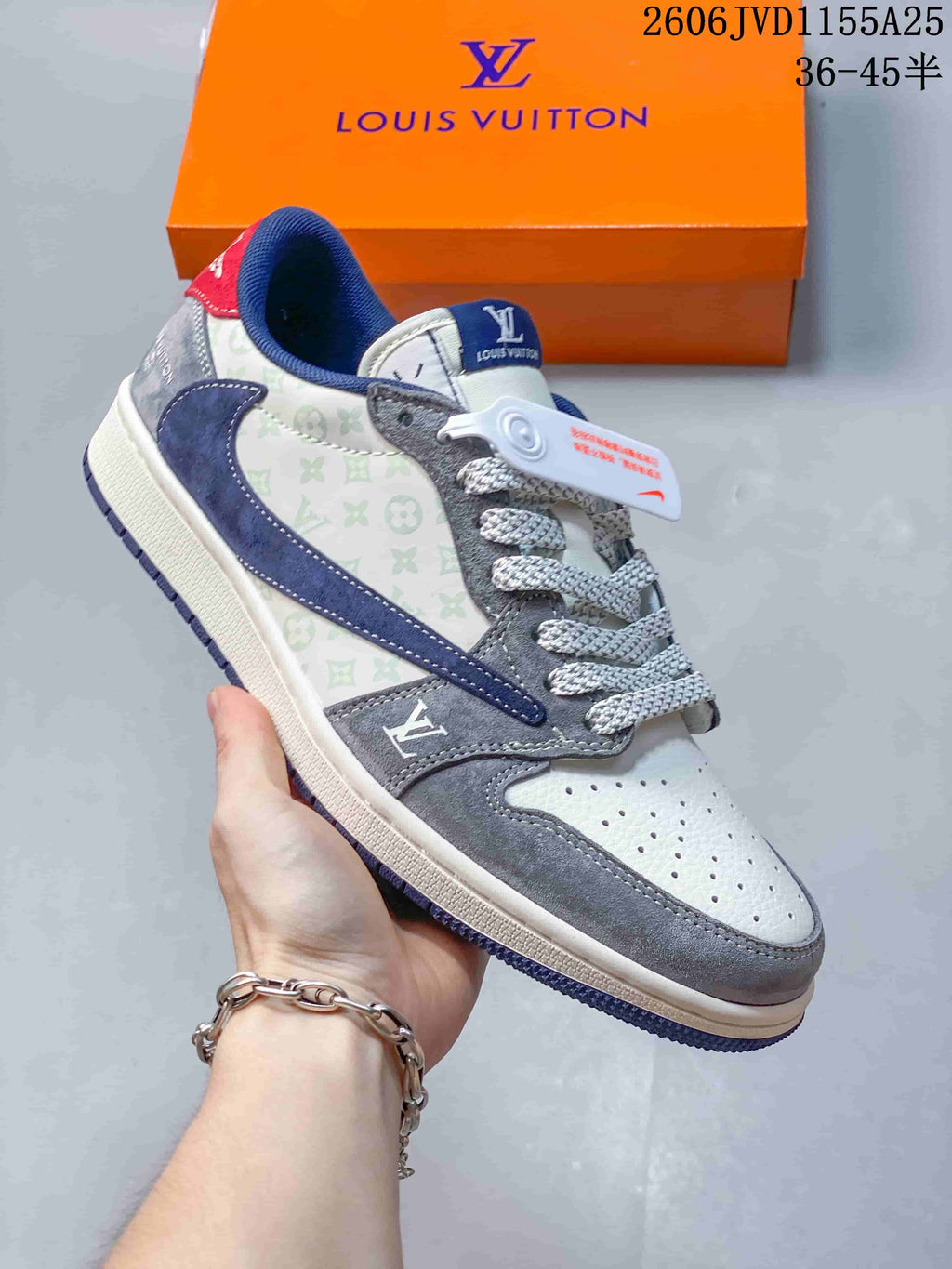 Close-up of a gray and navy low-top sneaker with patterned panels and thick laces