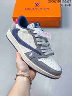 Close-up of a gray and navy low-top sneaker with patterned panels and thick laces