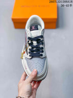 Top view of one sneaker showing dark navy laces, a perforated light gray toe box, white overlays, and tongue branding.