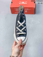 Top view of the navy high-top sneaker showing the white lacing, metal eyelets, stitching, and rubber toe cap.