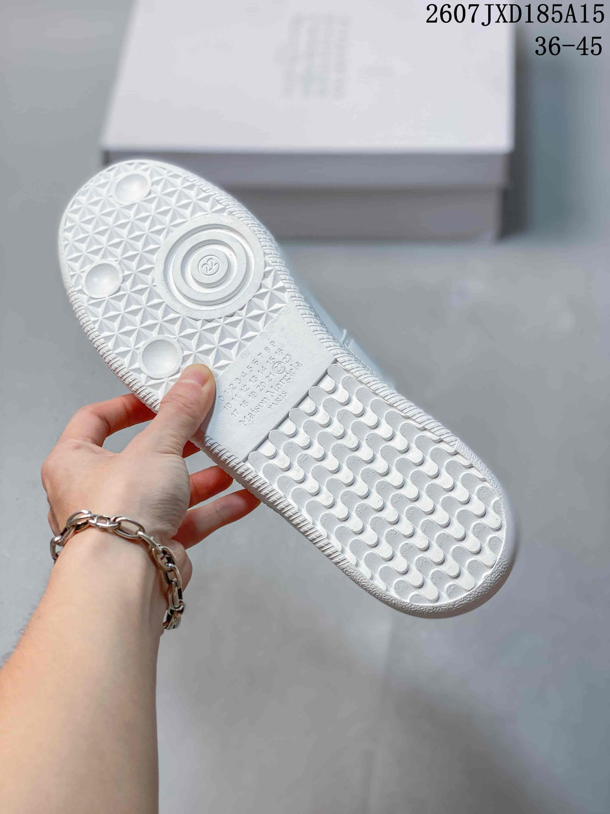Underside of a white sneaker showing the textured rubber outsole