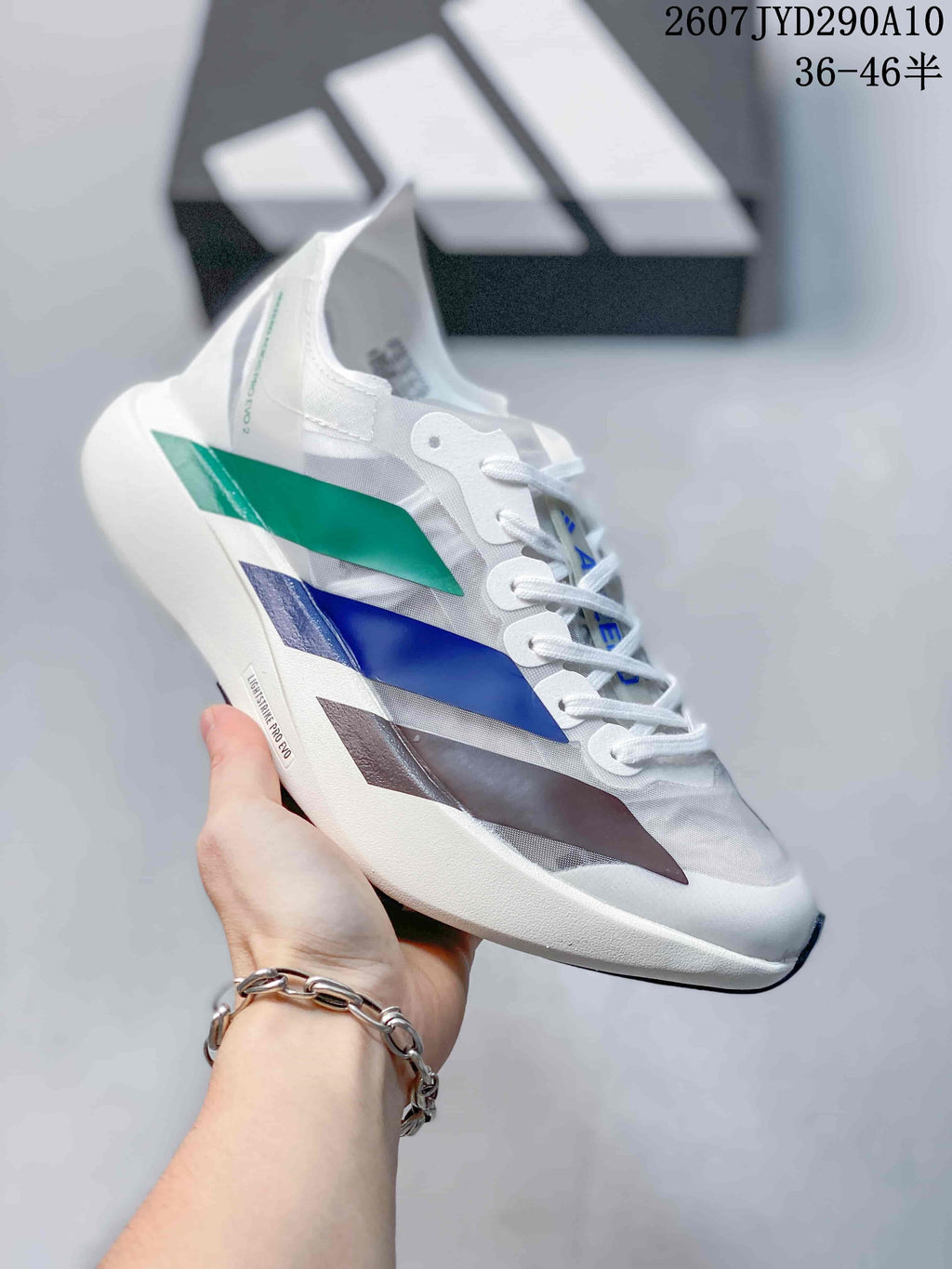 Angled side view showing the multicolor upper panels, lace closure and white running-shoe sole.