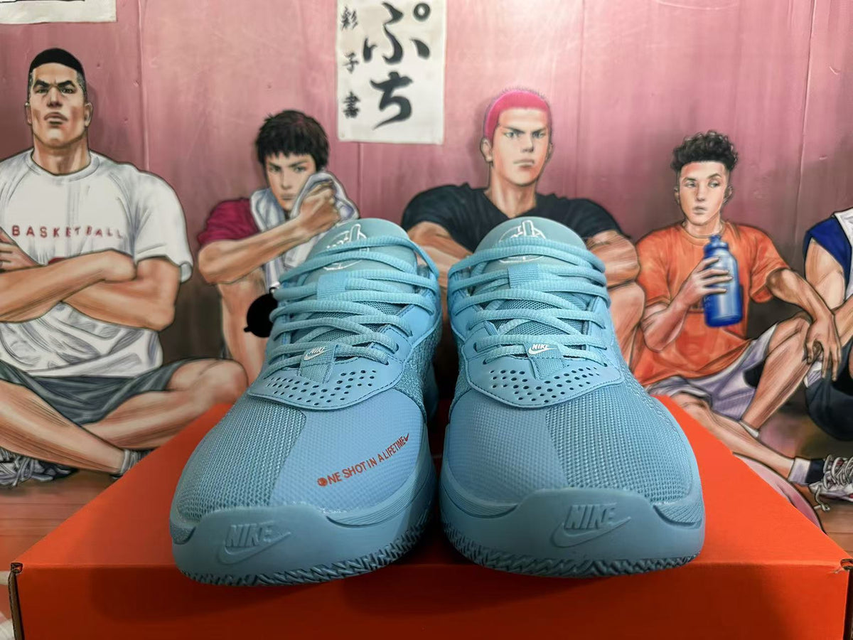 Front view of blue Nike basketball sneakers with matching laces, perforated forefoot panels, and visible Swoosh branding.