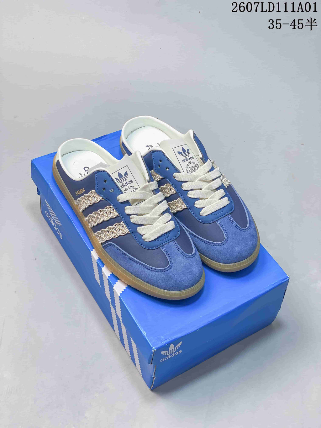 Pair of blue Adidas Originals Samba OG Mule low-top shoes with white laces and chain-style side stripes
