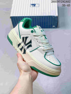 Close-up side view of a white MLB Chunky Liner sneaker with green trim, perforated toe panel and lace-up construction.