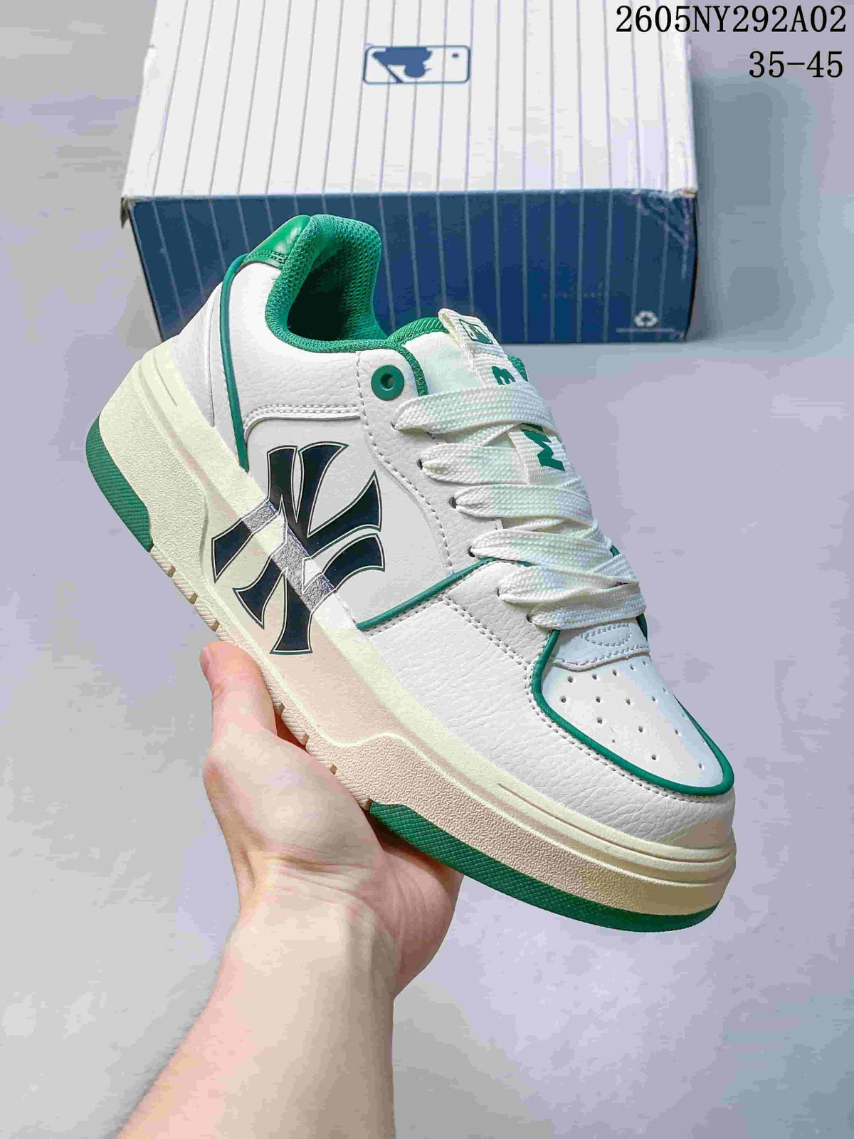 Close-up side view of a white MLB Chunky Liner sneaker with green trim, perforated toe panel and lace-up construction.