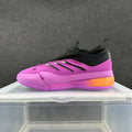 Side view of purple Adidas basketball-style sneakers with a black collar, three side stripes, and an orange heel accent.