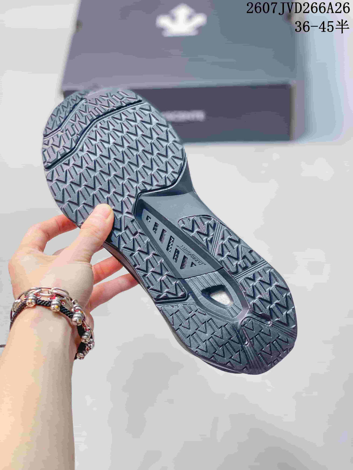 Underside view of the sneaker showing the textured directional outsole tread.