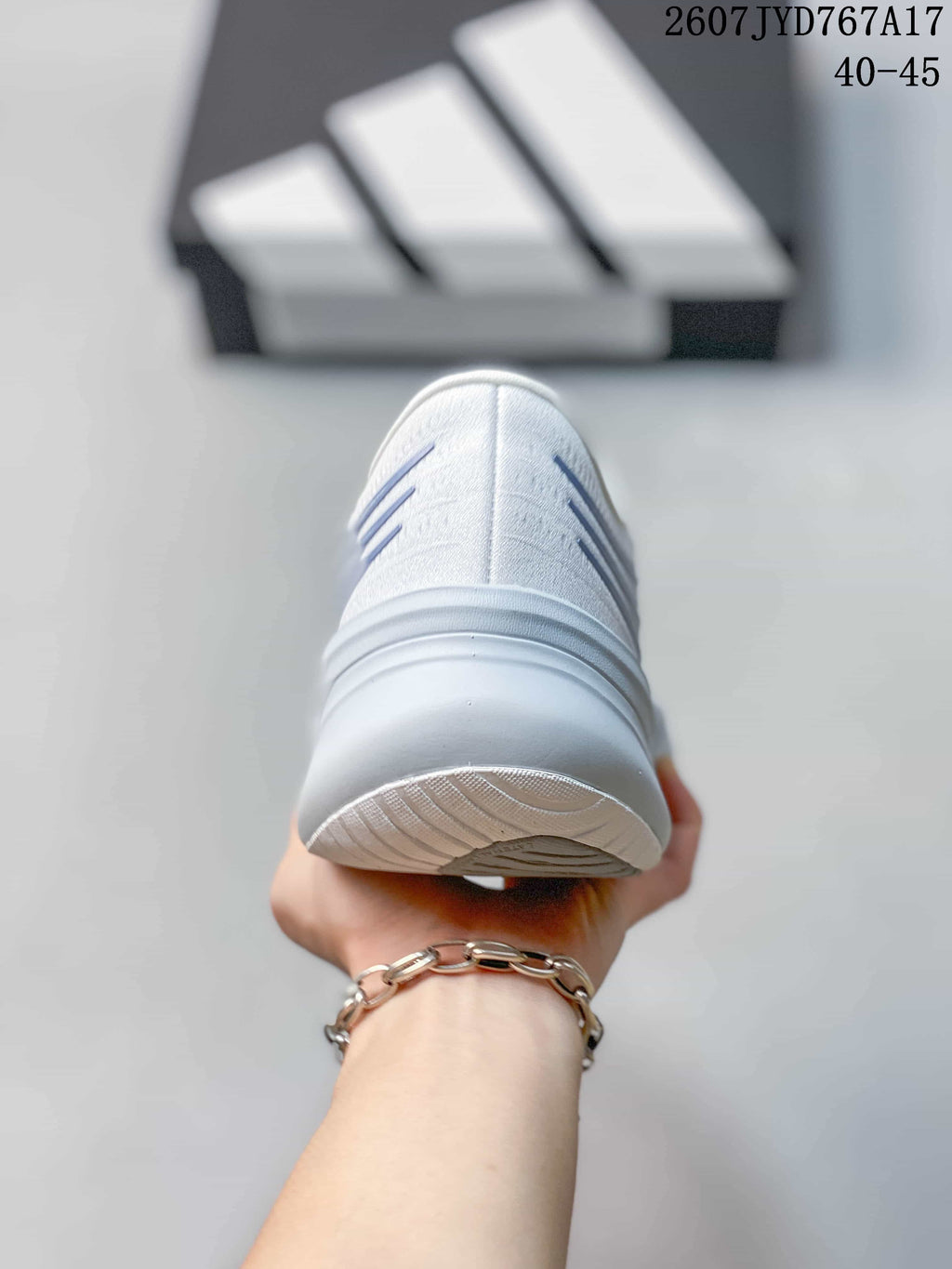 Rear view of the white sneaker showing the heel construction and outsole edge.