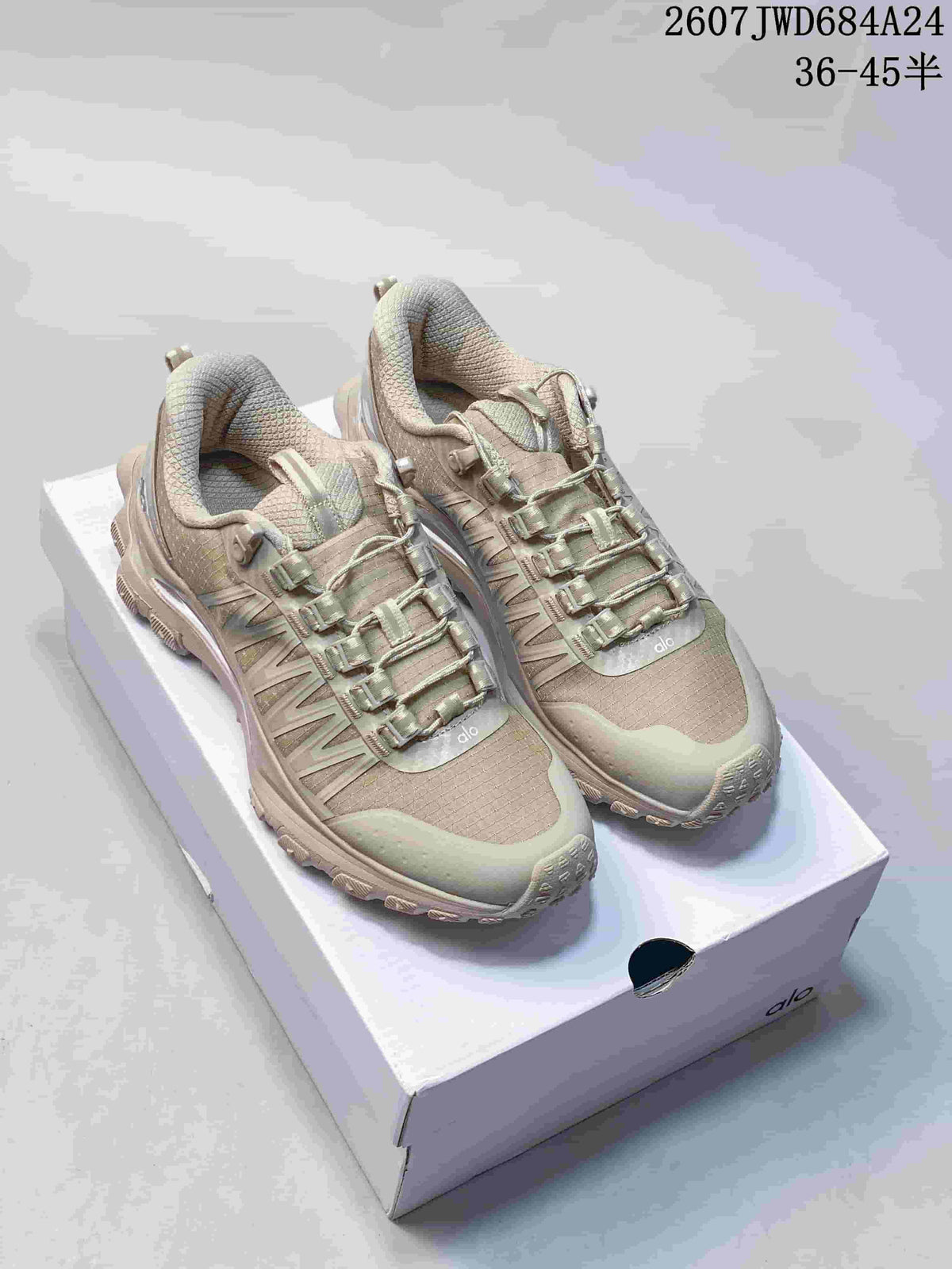 Pair of beige-toned Alo Recovery Mode sneakers displayed on a shoebox.