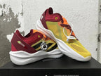 Pair of yellow, orange, and burgundy adidas Adizero sneakers shown at an angle.