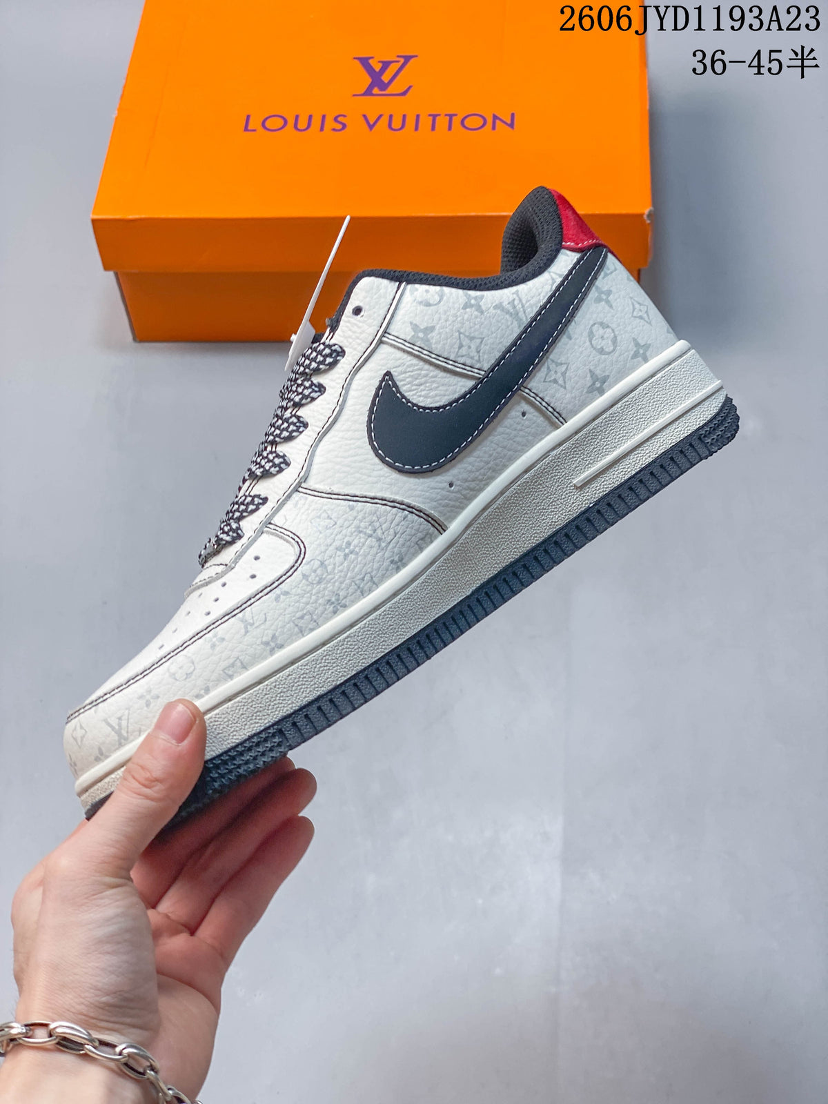 Side profile of a white and grey patterned low-top sneaker with a dark side panel
