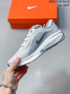 Side profile of the light gray Nike Journey Run shoe showing the mesh upper, swoosh detail and layered cushioned sole.