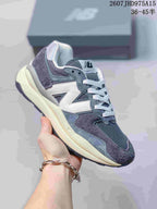 Dark gray New Balance 5740 sneaker with mesh panels and layered overlays.