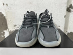 Front view showing perforated black and grey uppers, dark laces, and light-colored side panels.