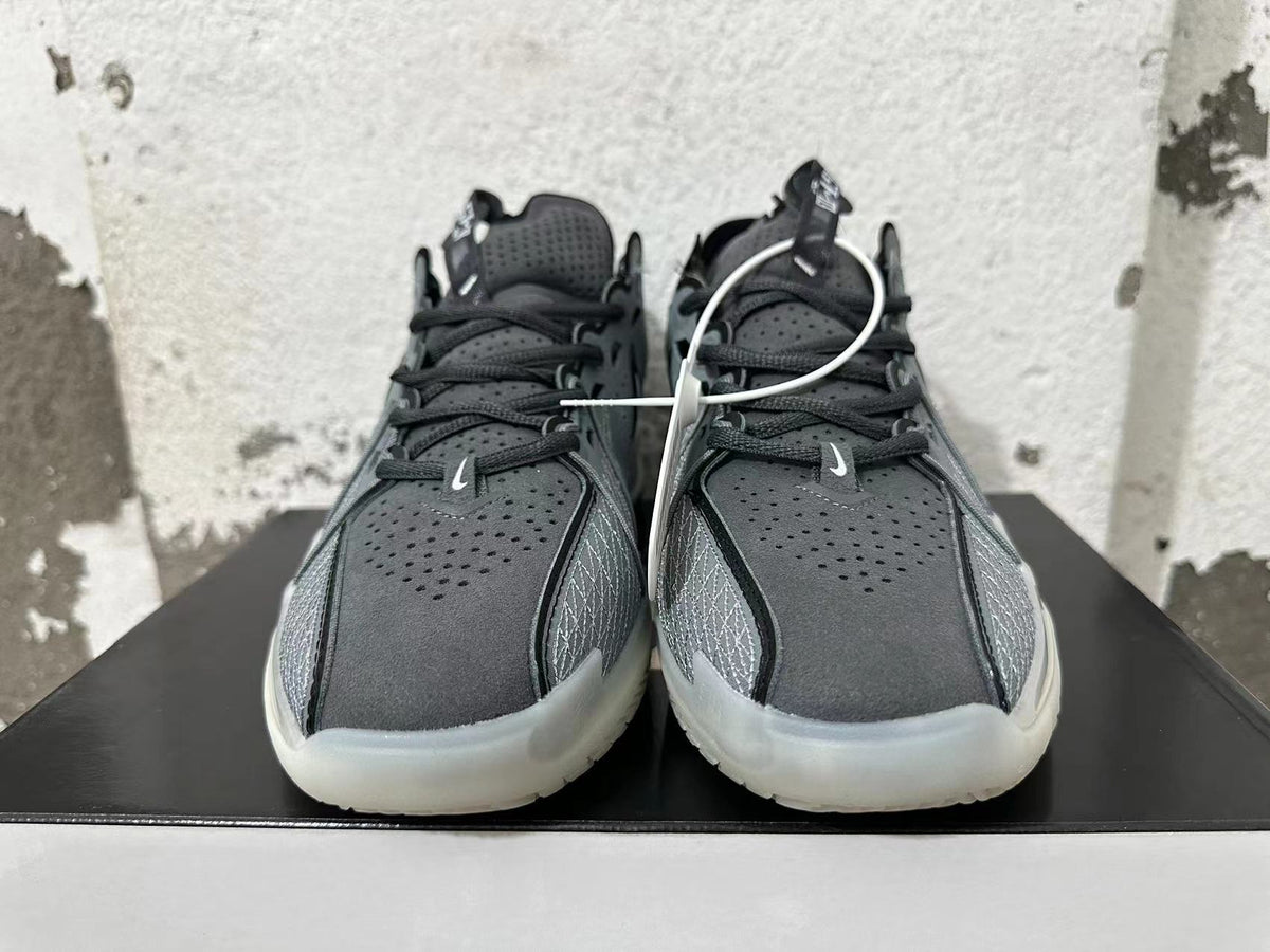 Front view showing perforated black and grey uppers, dark laces, and light-colored side panels.