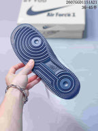Close-up of the navy rubber outsole showing concentric circular traction grooves and textured edges.