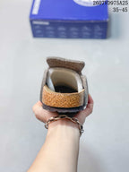 Rear view showing the open-back clog shape, contoured footbed, layered sole edge, and heel area.