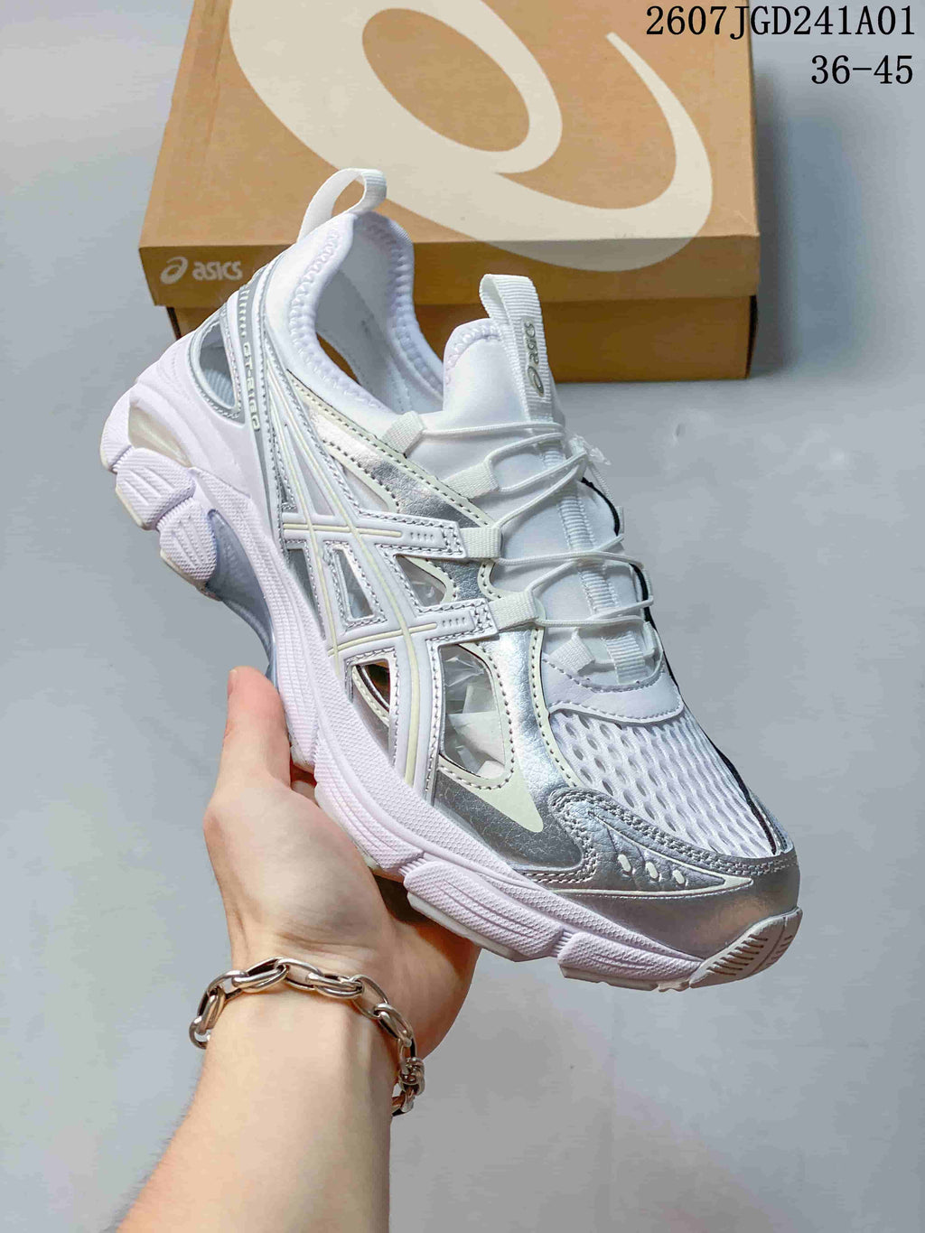 Angled view of a white and silver ASICS GT-2160 Breeze sneaker showing its side details and sole.