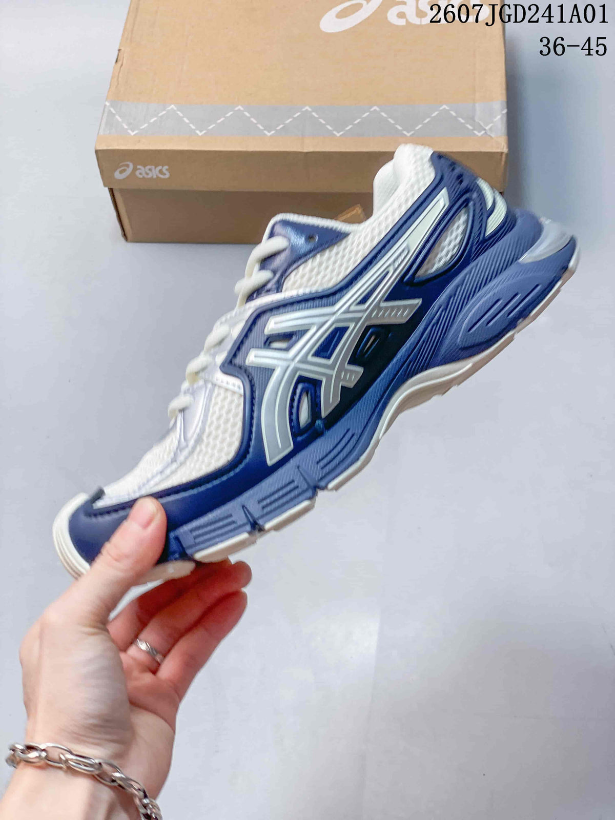 Side view of the white and navy sneaker with silver-tone ASICS side detailing