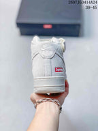 Rear view of a white mid-top sneaker showing the ankle strap, heel tab, raised sole, and red heel label.
